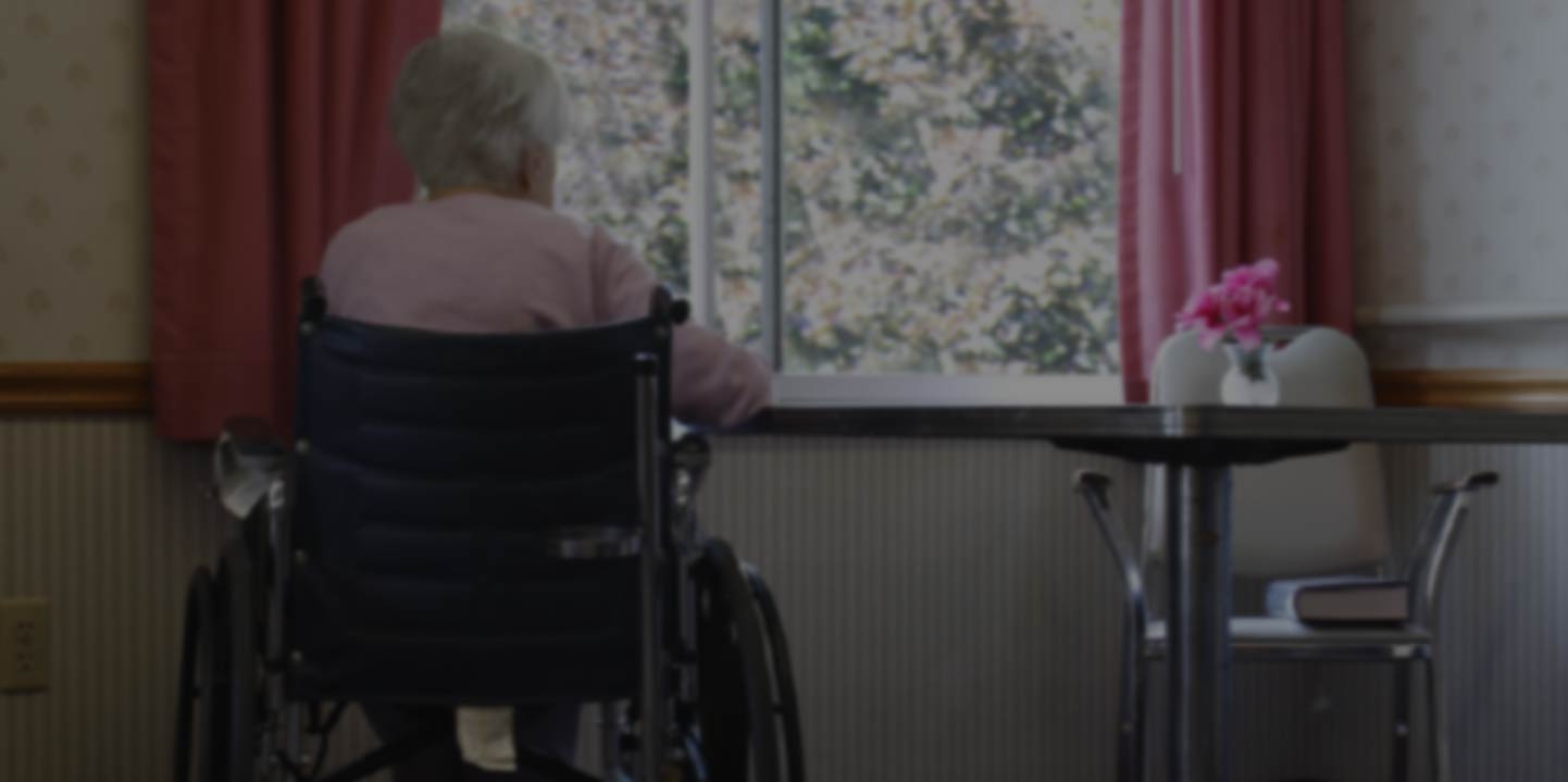 nursing home patient looking out of a window