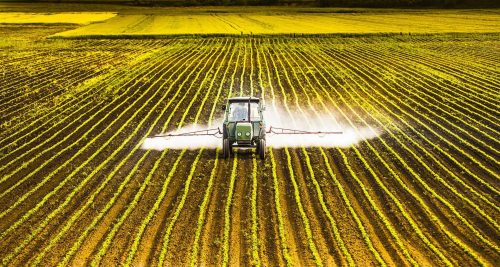 tractor on farm spreading paraquat